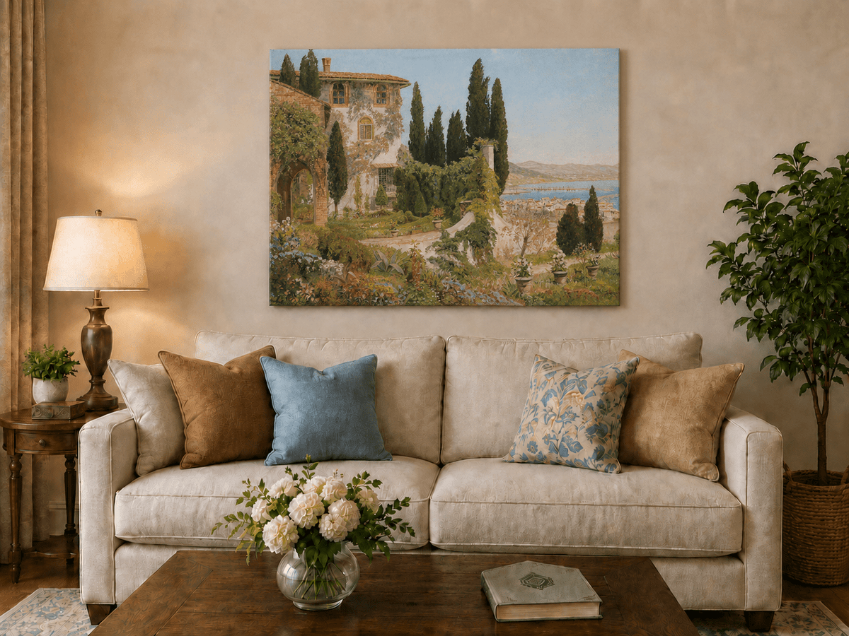 Unframed hand-painted Italian garden oil painting with cypress trees overlooking the sea displayed above a neutral living room sofa.