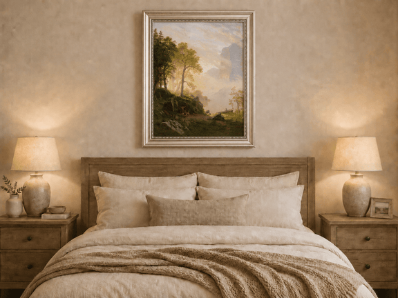 Framed hand-painted lakeside woodland oil painting with a camp, angler and misty peaks displayed above a wooden bed in a neutral bedroom.