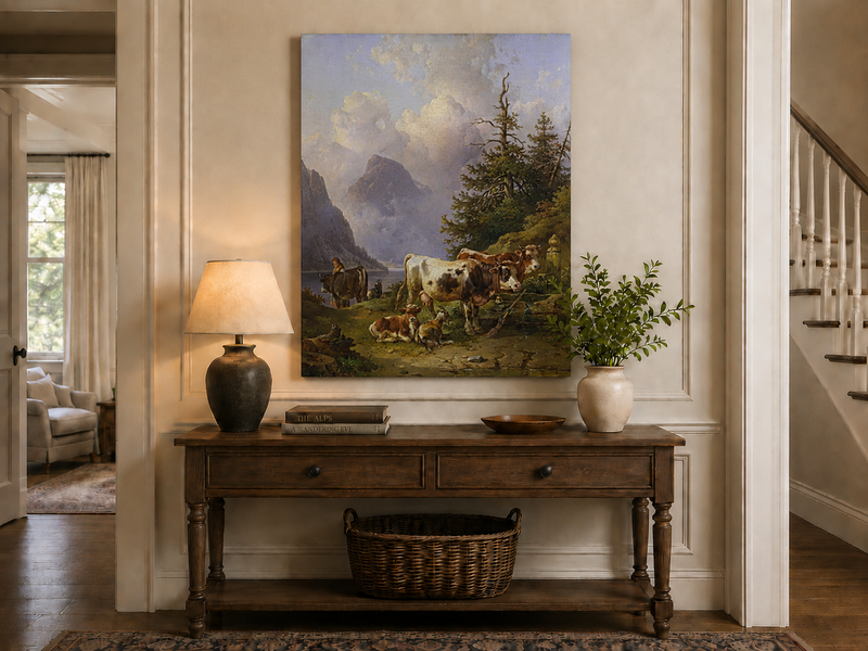 Hand-painted alpine lake with cattle, goats, herder and mountain landscape oil painting displayed above a console table in a hallway interior.