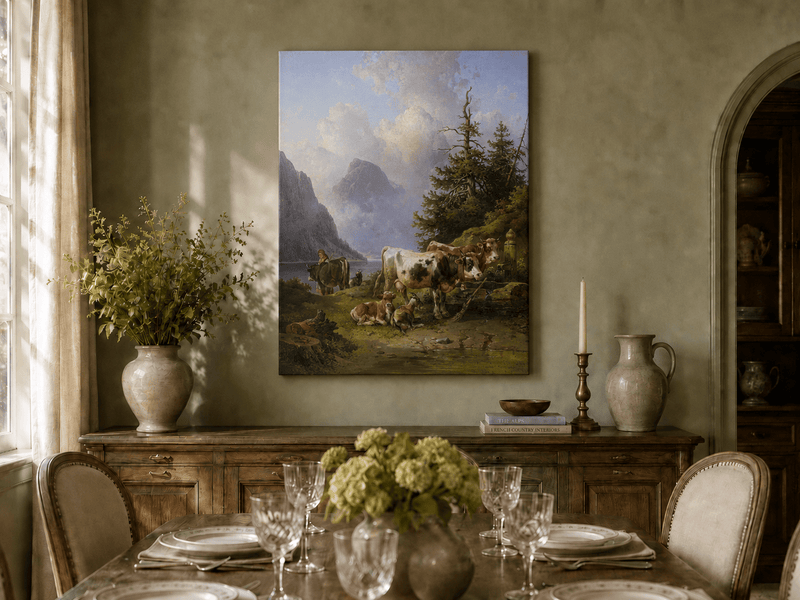 Hand-painted alpine lake with cattle, goats, herder and mountain landscape oil painting displayed in a dining room interior.