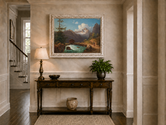 Hand-painted alpine river cabin and mountain valley landscape oil painting displayed above a console table in a hallway interior.