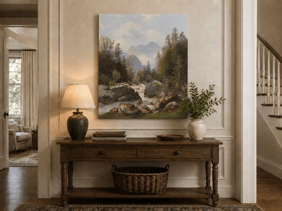 Hand-painted alpine stream with pines and boulders landscape oil painting displayed above a console table in a hallway interior.
