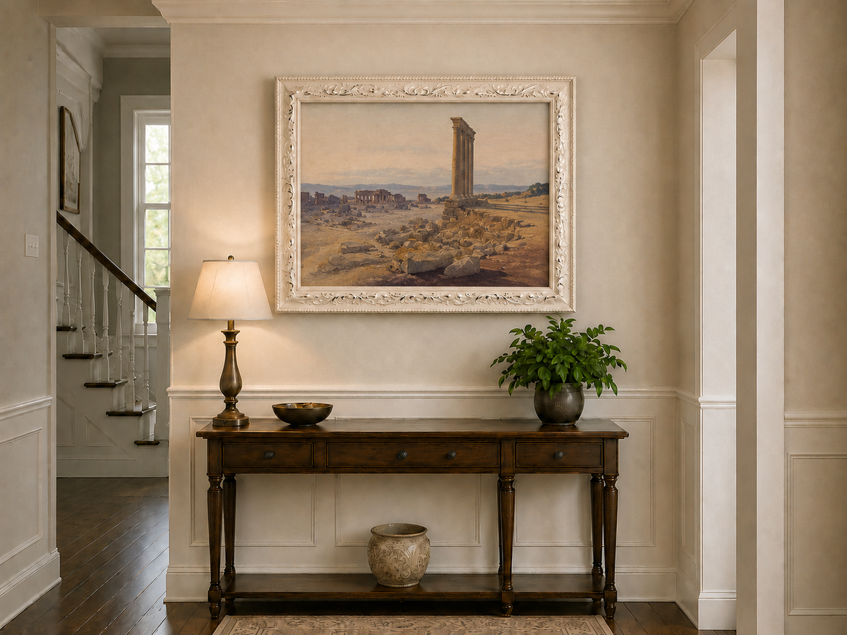Hand-painted ancient ruins with a column in the desert landscape oil painting displayed above a console table in a hallway interior.