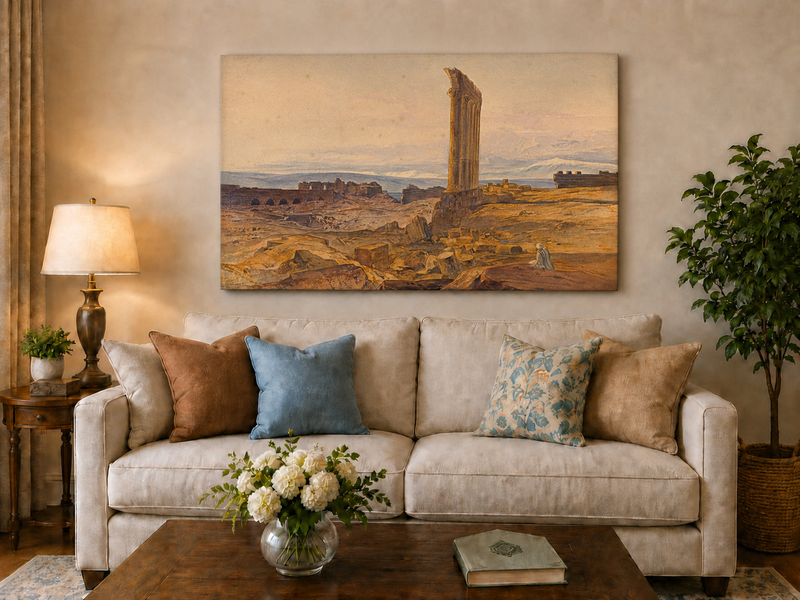 Hand-painted ancient ruins with a column in the desert landscape oil painting displayed above a sofa in a living room interior.