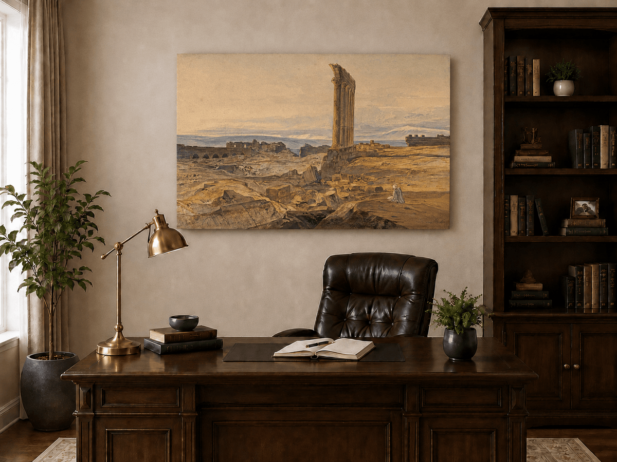 Hand-painted ancient ruins with a column in the desert landscape oil painting displayed above a desk in a home office interior.