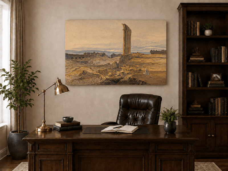 Hand-painted ancient ruins with a column in the desert landscape oil painting displayed above a desk in a home office interior.