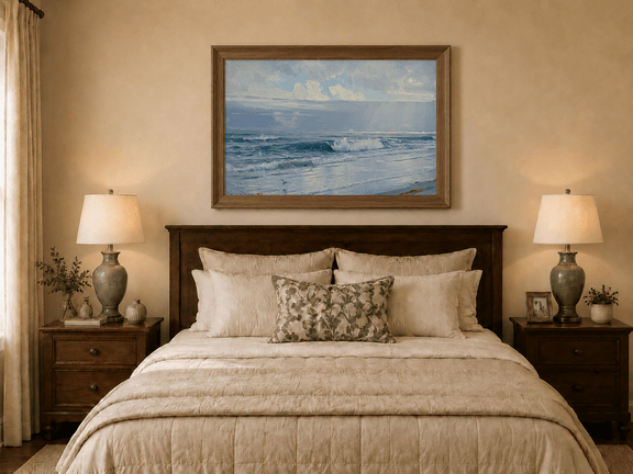 Framed hand-painted beach oil painting with crashing waves beneath cloudy seaside skies displayed above a wooden bed in a neutral bedroom.