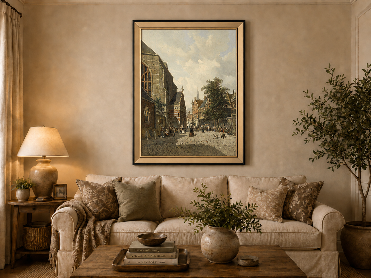 Charming town square with church and figures landscape oil painting displayed in a styled home interior.
