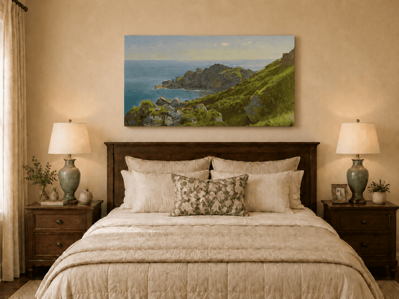 Unframed hand-painted coastal landscape oil painting with green hills, rocky headland and ocean displayed above a wooden bed in a neutral bedroom.