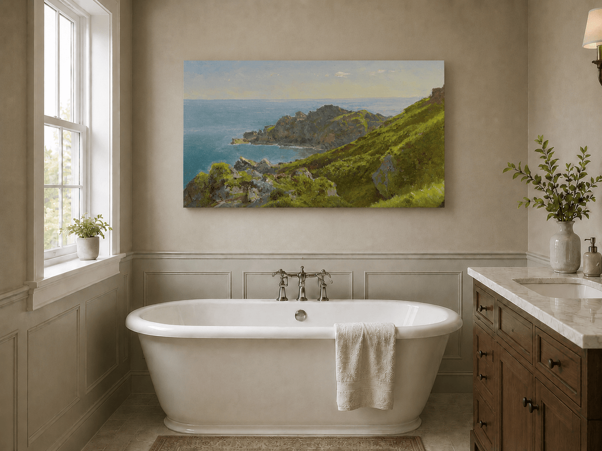 Unframed hand-painted coastal landscape oil painting with green hills, rocky headland and ocean displayed above a freestanding bathtub.