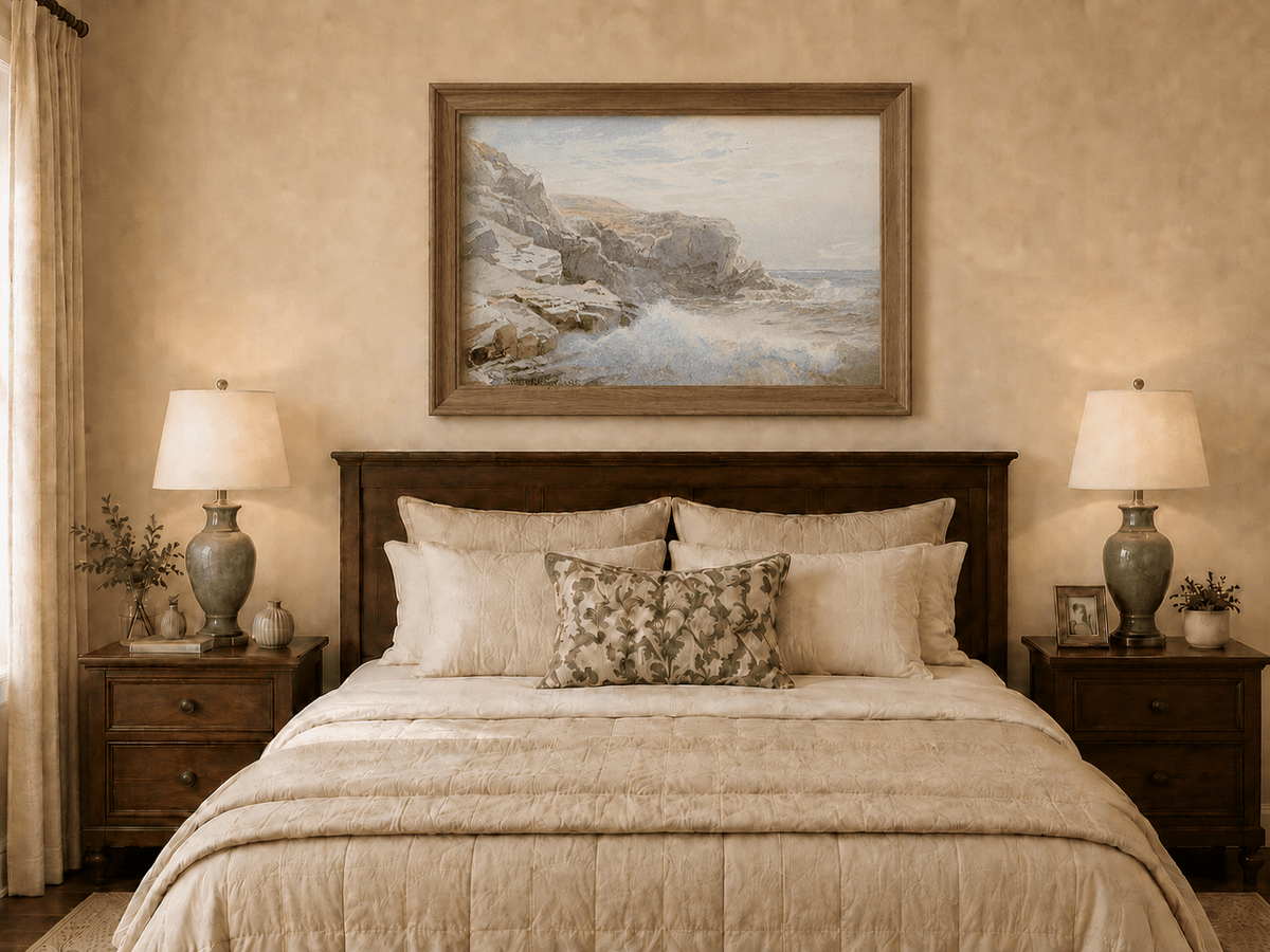 Framed hand-painted coastal cliffs oil painting with waves breaking along the rocky shore displayed above a wooden bed in a neutral bedroom.