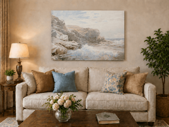 Unframed hand-painted coastal cliffs oil painting with waves breaking along the rocky shore displayed above a neutral living room sofa.