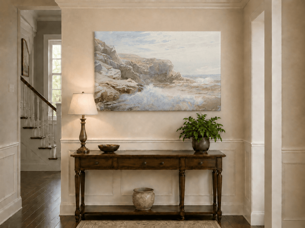 Unframed hand-painted coastal cliffs oil painting with waves crashing against pale rocks displayed above an entryway console table.