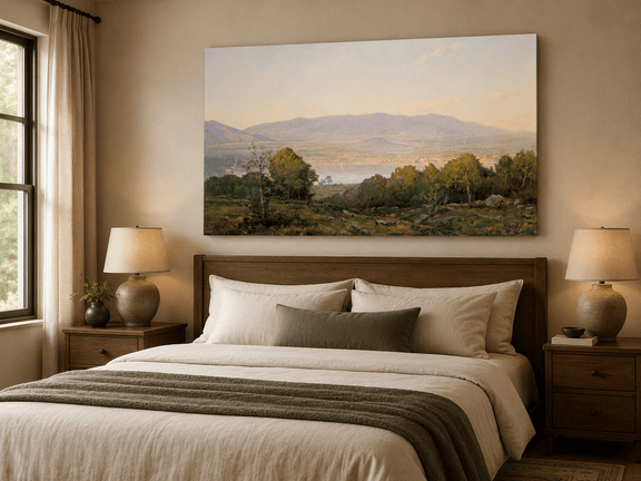 Unframed hand-painted dusk lake oil painting with distant mountains and wooded hills displayed above a wooden bed in a neutral bedroom.