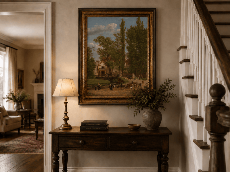 Hand-painted European country estate scene landscape oil painting displayed above a console table in a hallway interior.