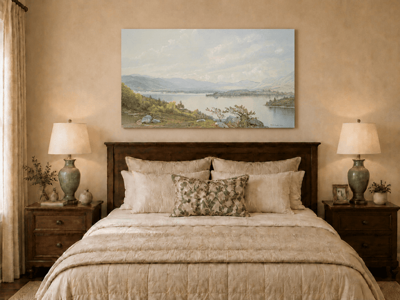 Unframed hand-painted expansive lake oil painting with distant mountains, trees and calm water displayed above a wooden bed in a neutral bedroom.