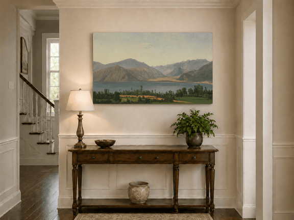Hand-painted Lake Fucino and Abruzzi Mountains landscape oil painting displayed above a console table in a hallway interior.