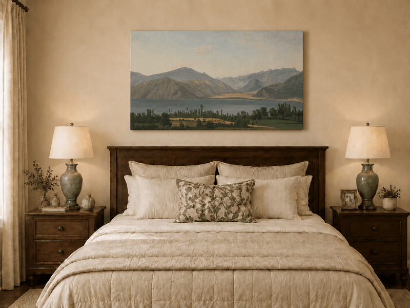 Hand-painted Lake Fucino and Abruzzi Mountains landscape oil painting displayed above a bed in a bedroom interior.