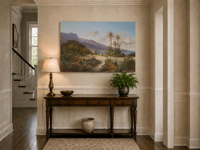 Hand-painted Mediterranean coastal garden with peaks and figures landscape oil painting displayed above a console table in a hallway interior.
