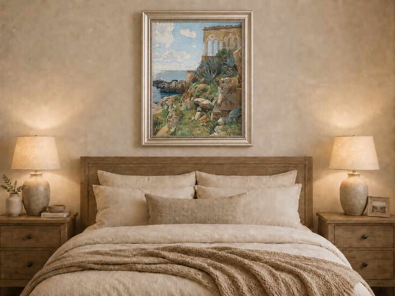 Hand-painted Mediterranean coastal ruins with arch and succulents landscape oil painting displayed above a bed in a bedroom interior.