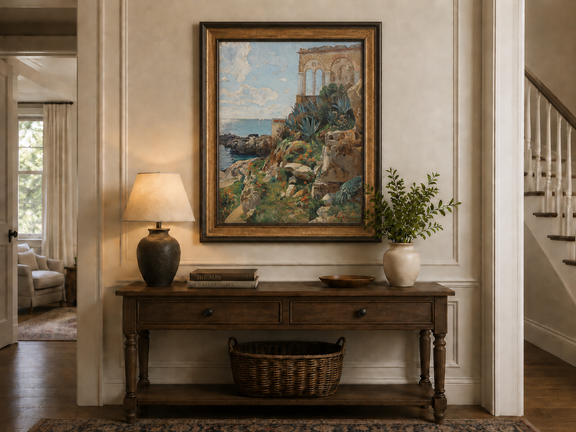 Hand-painted Mediterranean coastal ruins with arch and succulents landscape oil painting displayed above a console table in a hallway interior.