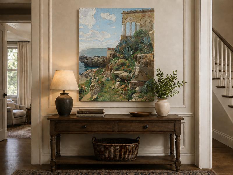 Hand-painted Mediterranean coastal ruins with arch and succulents landscape oil painting displayed above a console table in a hallway interior.
