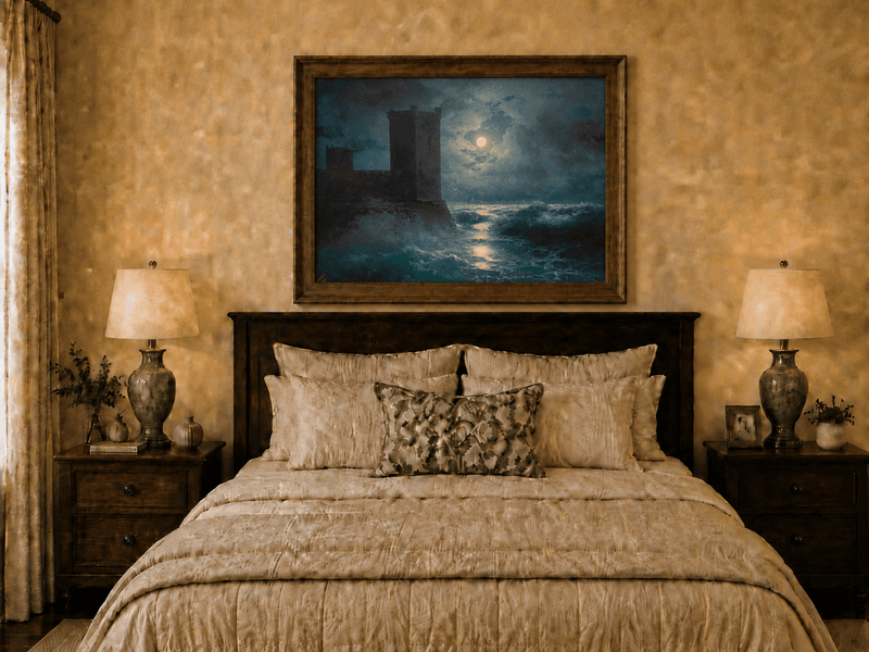 Hand-painted moonlit sea and coastal castle landscape oil painting displayed above a bed in a bedroom interior.