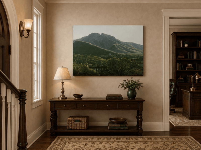 Hand-painted mountain view with bridge and greenery landscape oil painting displayed above a console table in a hallway interior.