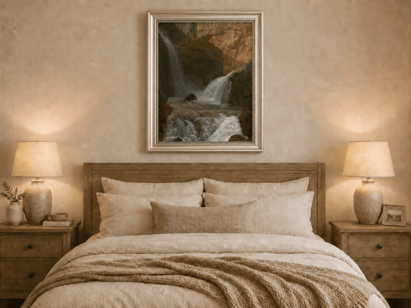 Hand-painted mountain waterfall in a rocky gorge landscape oil painting displayed above a bed in a bedroom interior.