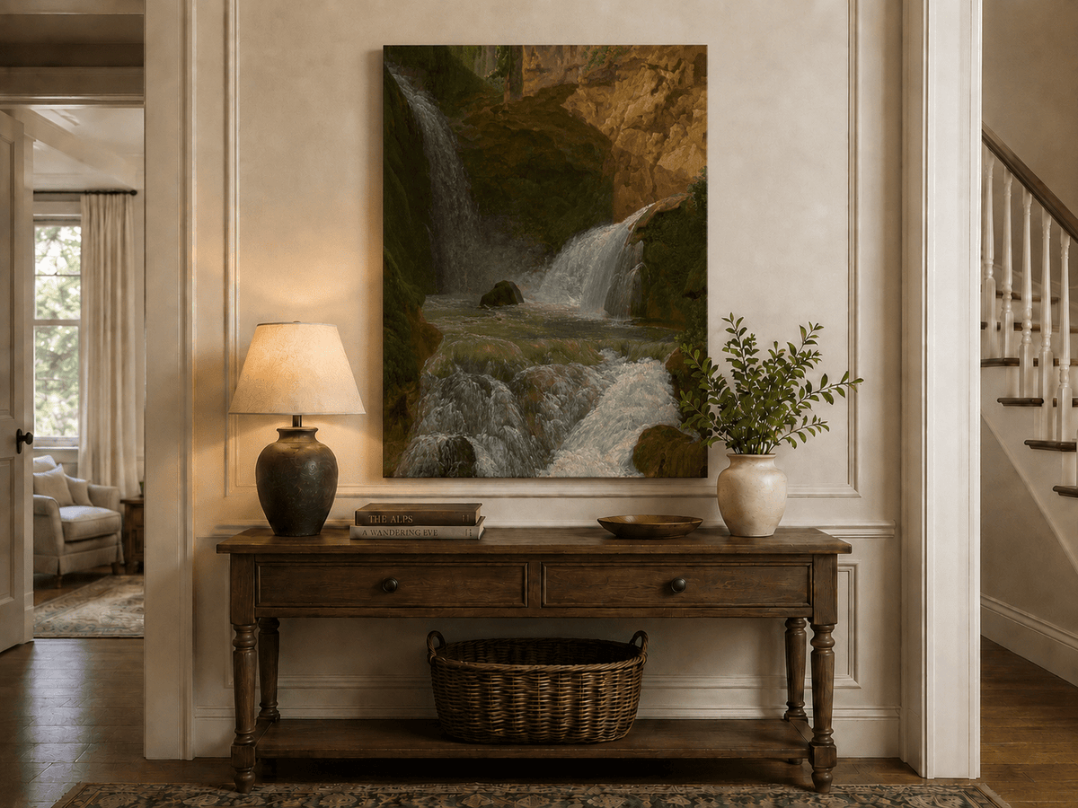 Hand-painted mountain waterfall in a rocky gorge landscape oil painting displayed above a console table in a hallway interior.