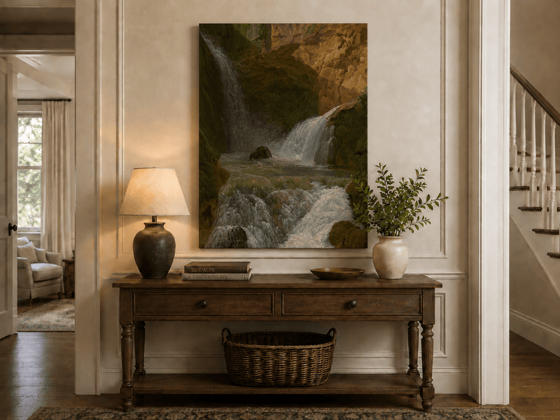 Hand-painted mountain waterfall in a rocky gorge landscape oil painting displayed above a console table in a hallway interior.