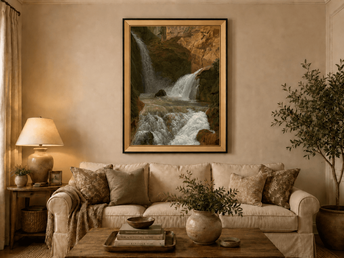 Hand-painted mountain waterfall in a rocky gorge landscape oil painting displayed above a sofa in a living room interior.