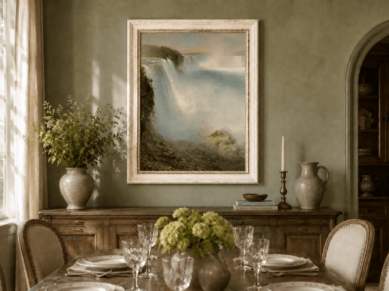 Niagara Falls and rushing water oil landscape artwork shown in a styled home interior.