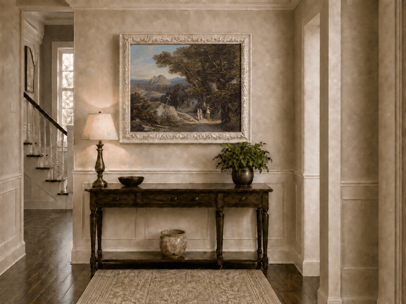 Hand-painted path with figures, cross and distant mountain peaks landscape oil painting displayed above a console table in a hallway interior.