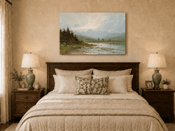 Unframed hand-painted lake shore oil painting with pine shade, still water and mountain peaks displayed above a wooden bed in a neutral bedroom.