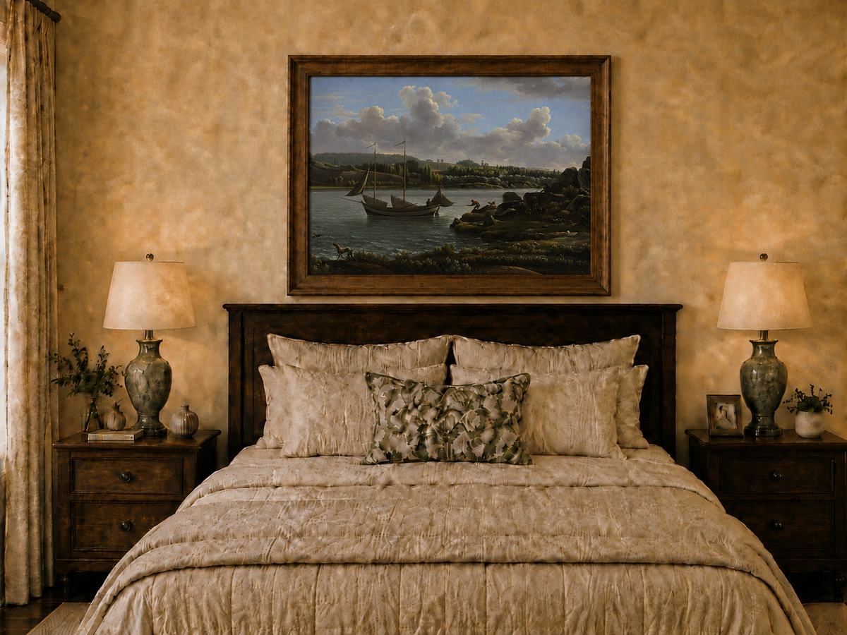 Hand-painted riverside sailboat with figures, dogs and distant hills landscape oil painting displayed above a bed in a bedroom interior.