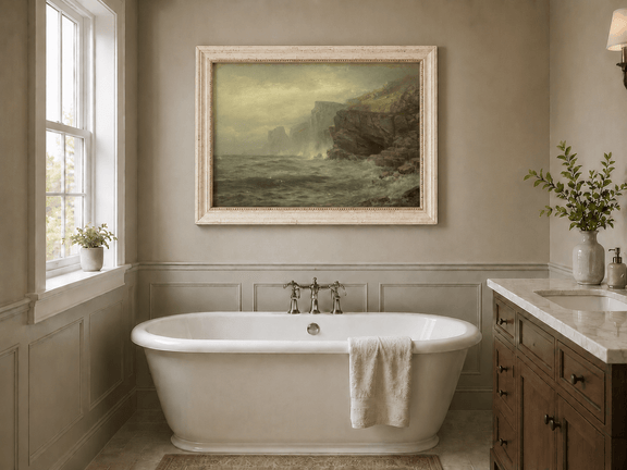 Framed hand-painted rocky seaside oil painting with churning waves and misty cliffs displayed above a freestanding bathtub.