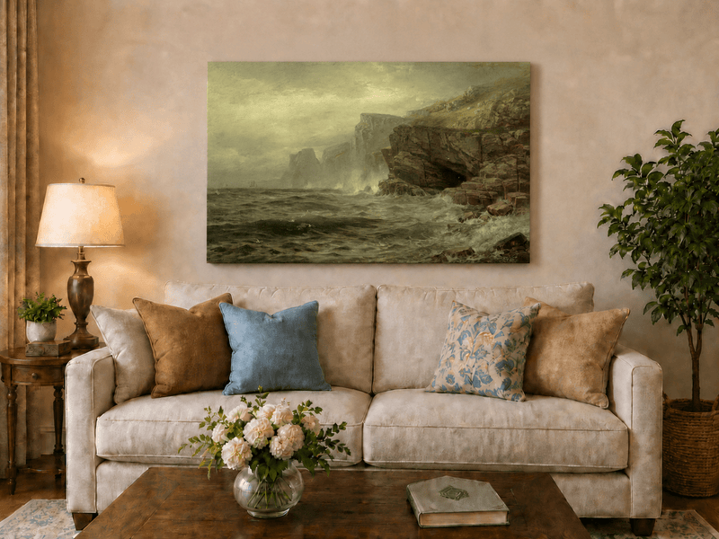 Unframed hand-painted rocky seaside oil painting with churning waves and misty cliffs displayed above a neutral living room sofa.