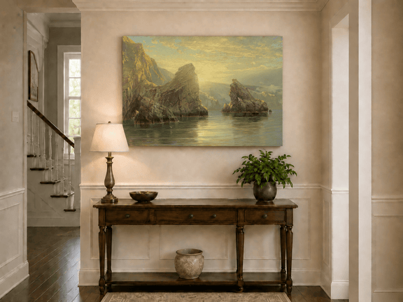 Unframed hand-painted seascape oil painting with rock cliffs, calm water and glowing skies displayed above an entryway console table.