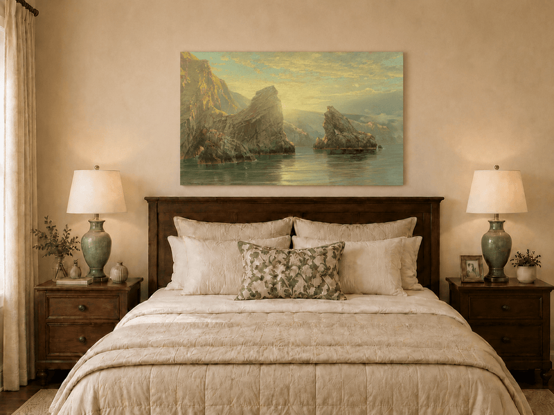 Unframed hand-painted seascape oil painting with rock cliffs, calm water and glowing skies displayed above a wooden bed in a neutral bedroom.
