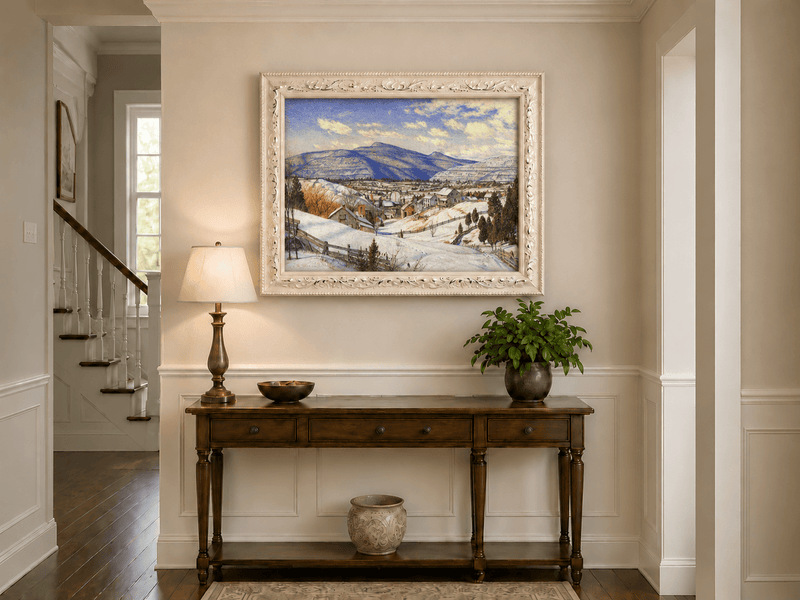 Hand-painted Snowy Mountain Village in Winter Light landscape oil painting displayed as wall art in a styled interior