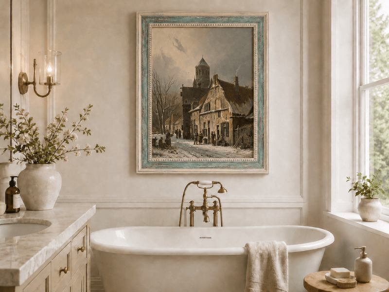 Snowy town street with figures and old buildings oil landscape artwork shown in a styled home interior.