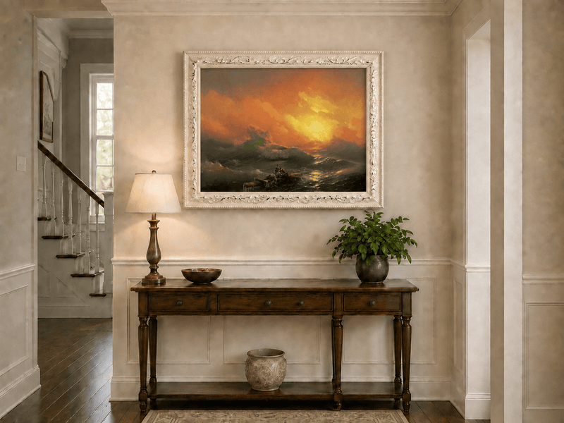 Hand-painted stormy sea with raft at sunset landscape oil painting displayed above a console table in a hallway interior.