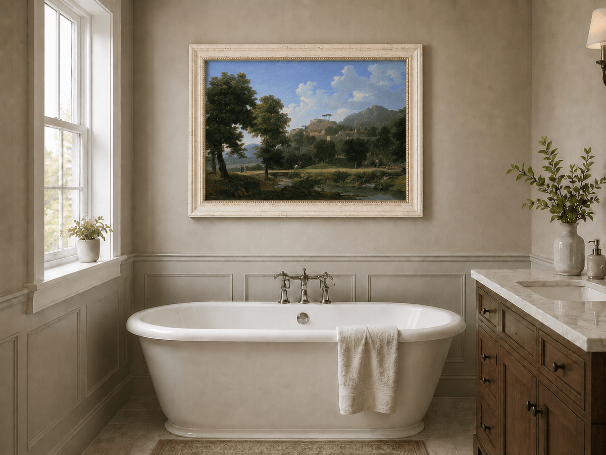 Hand-painted sunlit hill village and river view landscape oil painting displayed in a bathroom interior above a bathtub.