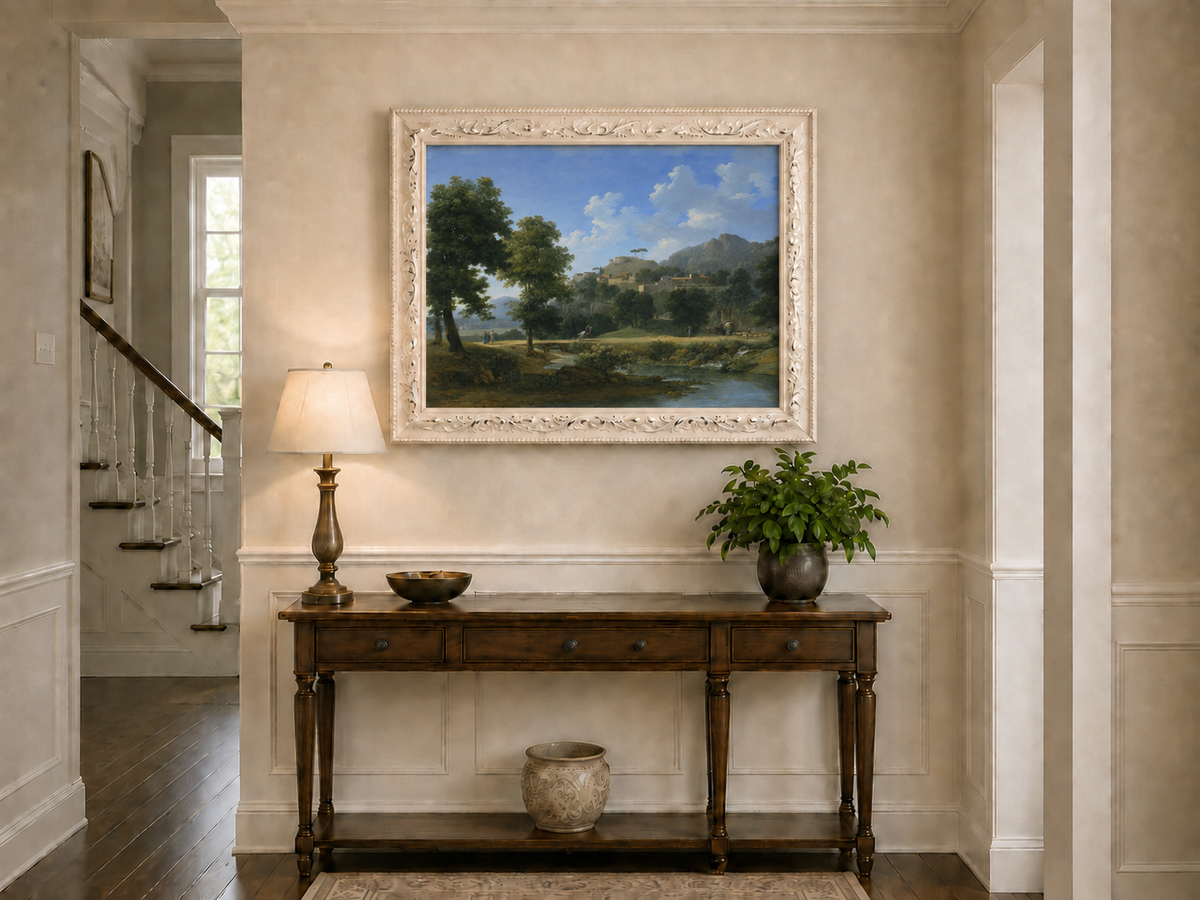 Hand-painted sunlit hill village and river view landscape oil painting displayed above a console table in a hallway interior.