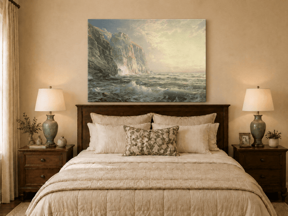 Unframed hand-painted coastal oil painting with tall cliffs, rolling waves and glowing skies displayed above a wooden bed in a neutral bedroom.