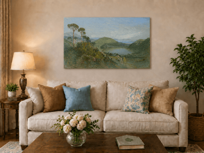 Unframed hand-painted valley lake oil painting with tall pines, a blue bay and green hills displayed above a neutral living room sofa.
