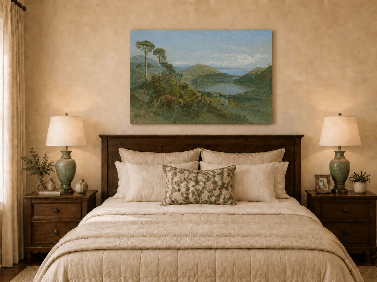 Unframed hand-painted valley lake oil painting with tall pines, a blue bay and green hills displayed above a wooden bed in a neutral bedroom.