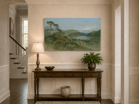 Unframed hand-painted valley lake oil painting with tall pines, a blue bay and green hills displayed above an entryway console table.