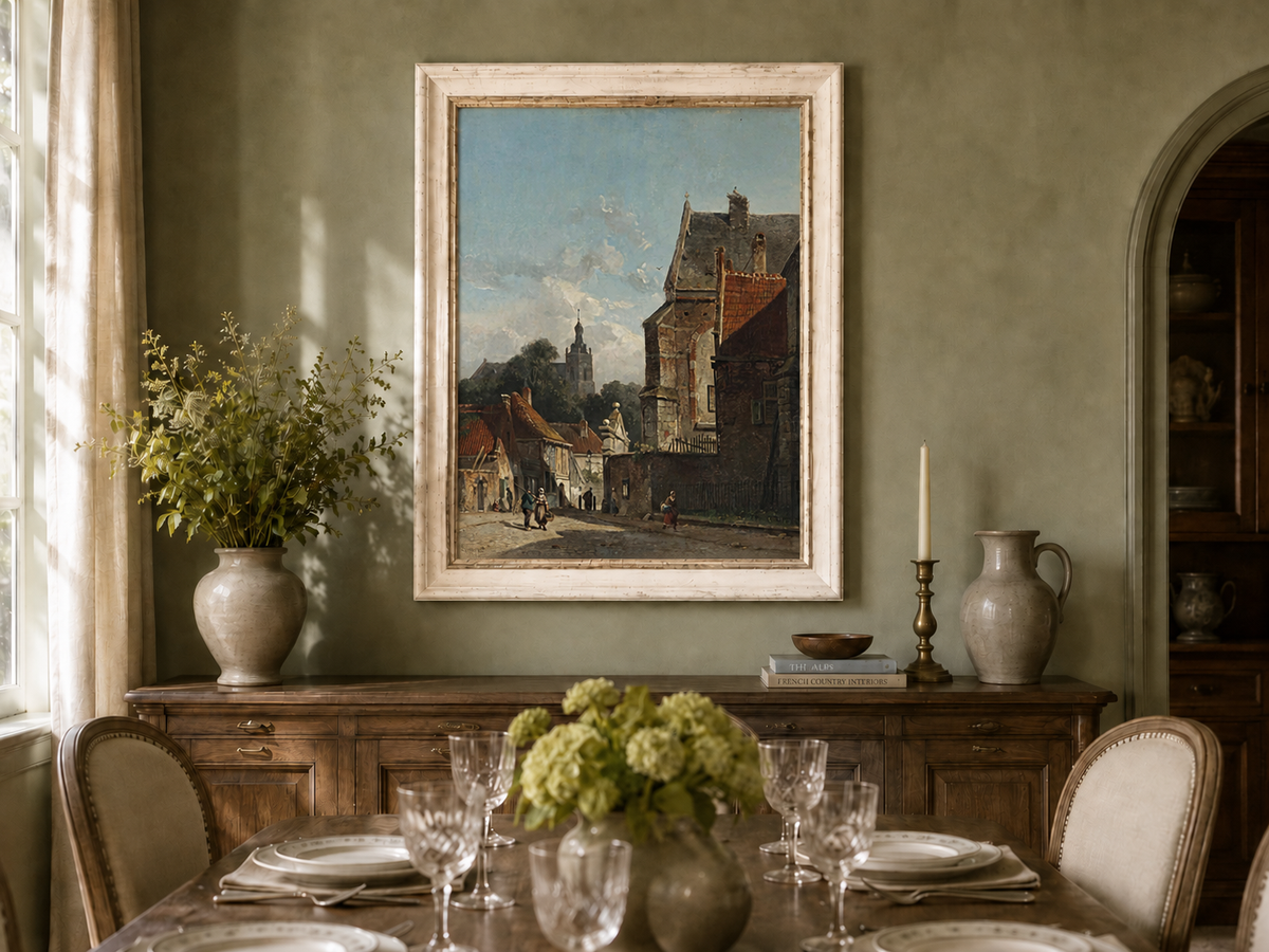 Town street with old buildings and tower oil landscape artwork shown on a wall in a styled home interior.